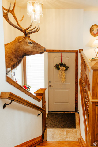 322 Bailey Creek Road Soda Springs, ID 83276 - Photo 4 of 32 Hardwood staircase with detailed railing, leading to a tiled entry landing