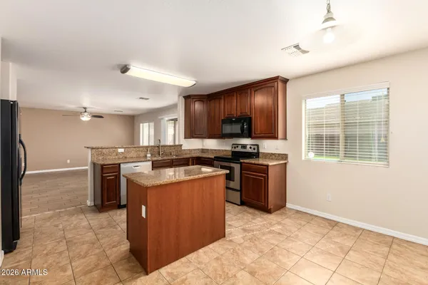a kitchen with a stove top oven and refrigerator