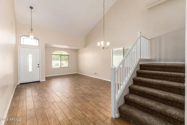 a view of an empty room with stairs and ventilation