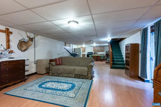 a kitchen with a table chairs refrigerator and microwave