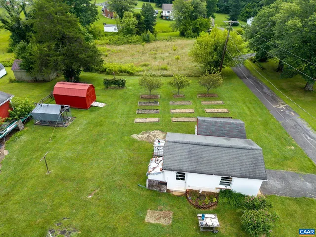 an aerial view of green landscape with trees houses and mountain view