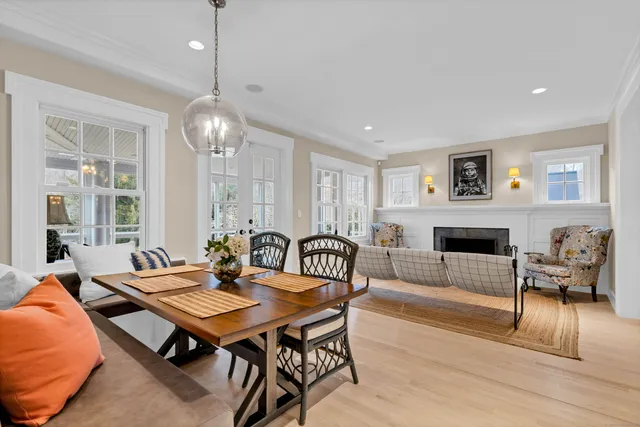 a living room with furniture a table and a fireplace