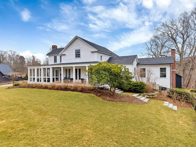 a front view of house with yard and swimming pool