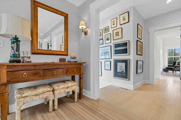 a living room with furniture and paintings on the wall