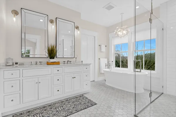 a spacious bathroom with sinks mirror and a shower