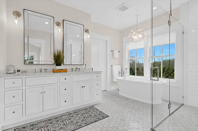 a spacious bathroom with sinks mirror and a shower