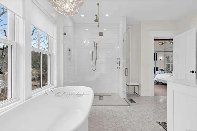 a bathroom with a tub sink and shower