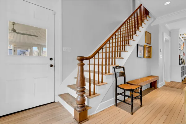 a view of staircase with furniture and wooden floor