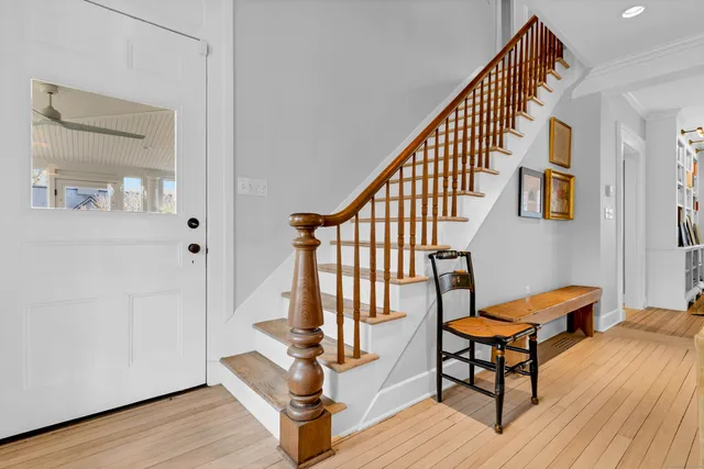 a view of staircase with furniture and wooden floor
