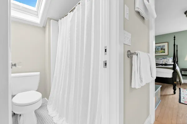 a bathroom with a toilet sink and a mirror