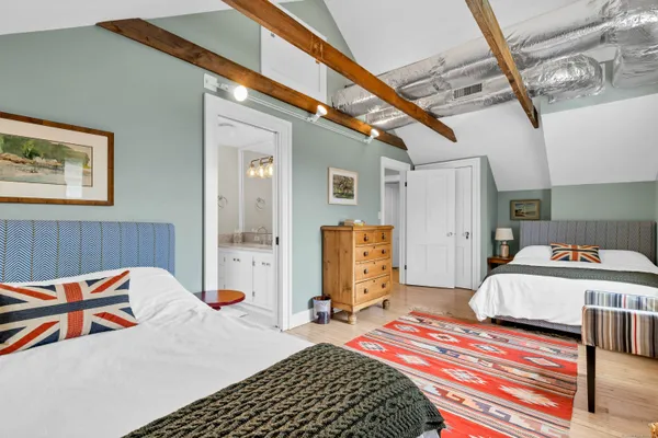 a bedroom with bed and a chandelier