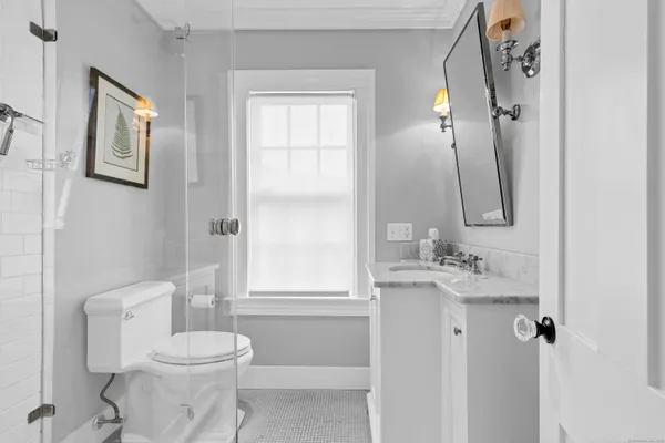 a bathroom with a toilet sink and a mirror