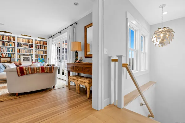 a living room with furniture and a floor to ceiling window