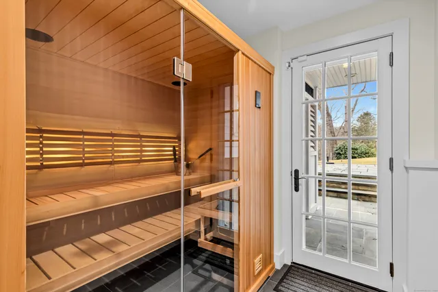 a view of bedroom with a balcony and wooden floor