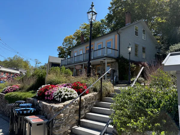 a view of a house with backyard and sitting area