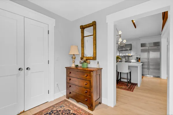a kitchen with a refrigerator and table chair