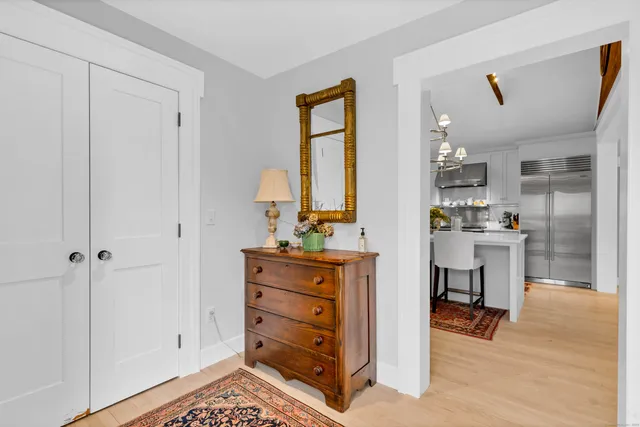 a kitchen with a refrigerator and table chair