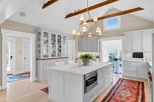 a kitchen with a stove cabinets and wooden floor