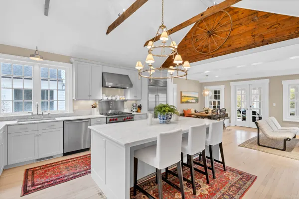 a kitchen with a table chairs stove and cabinets