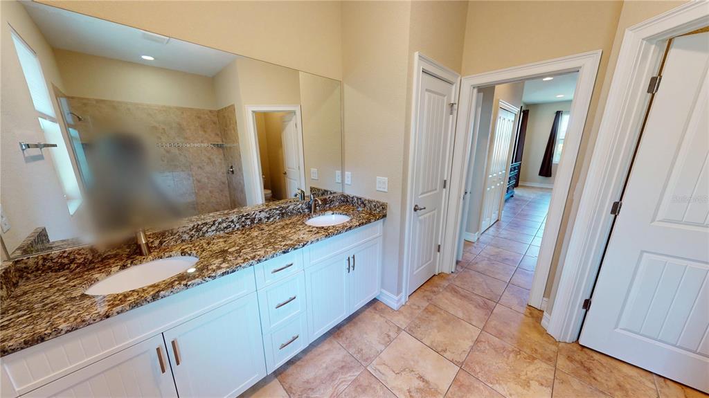 7342 North Ficus Tree Punta Gorda, FL 33955 - Photo 19 of 34 a spacious bathroom with a granite countertop sink and a mirror