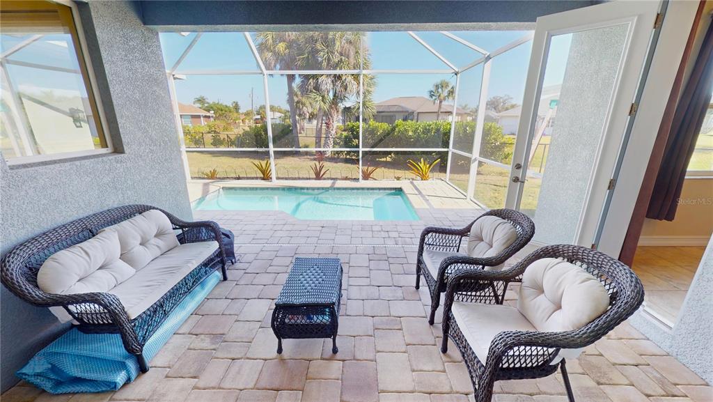 7342 North Ficus Tree Punta Gorda, FL 33955 - Photo 27 of 34 a living room with furniture and a floor to ceiling window