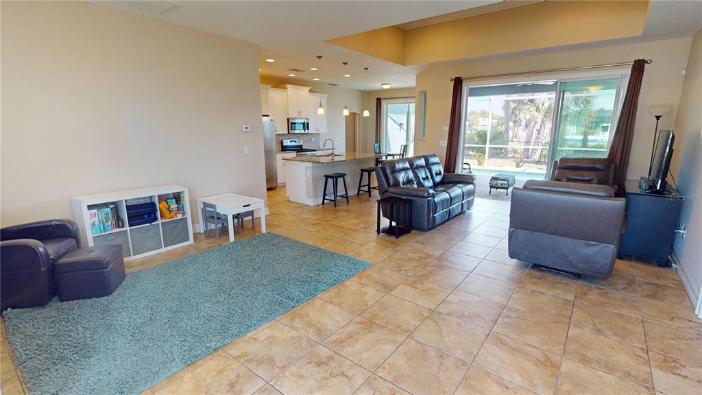 7342 North Ficus Tree Punta Gorda, FL 33955 - Photo 5 of 34 a living room with furniture and a dining table with rug kitchen