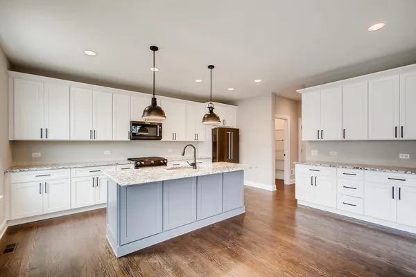 a kitchen with stainless steel appliances granite countertop a stove sink and cabinets