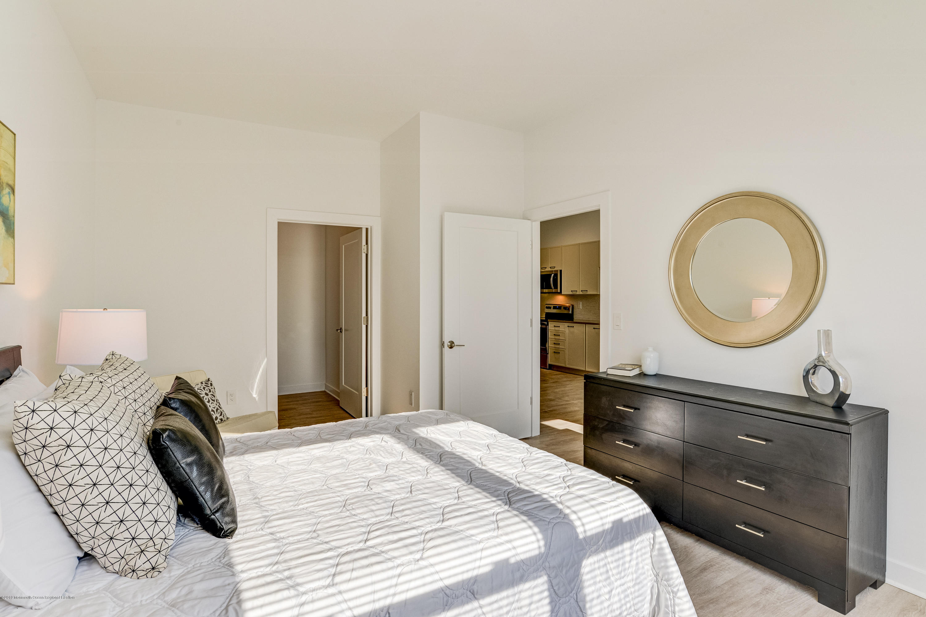 55 West Front Street, Unit 306 Red Bank, NJ 07701 - Photo 13 of 24 a bedroom with a bed and a dresser
