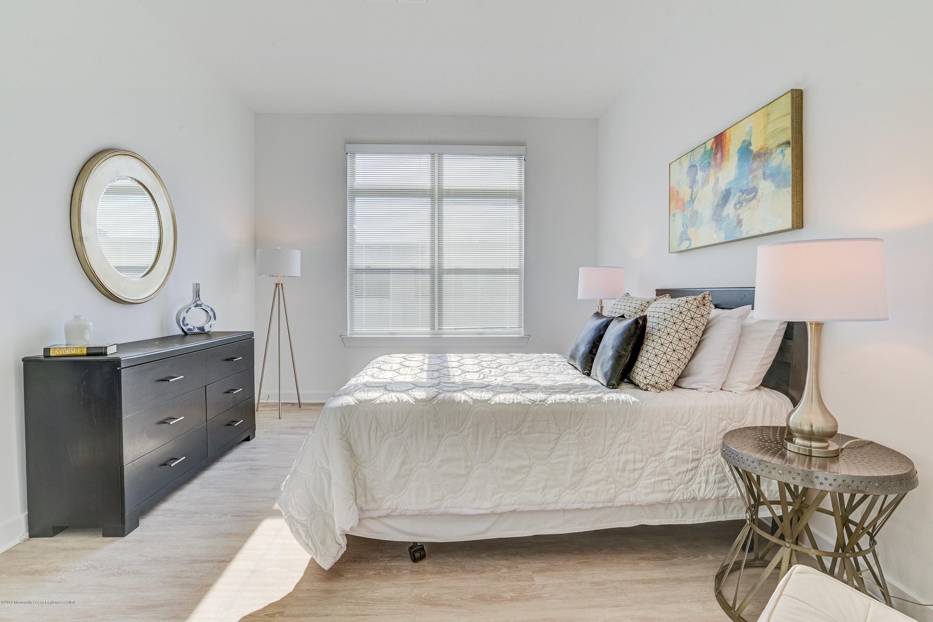 55 West Front Street, Unit 306 Red Bank, NJ 07701 - Photo 14 of 24 a bedroom with a bed and a table