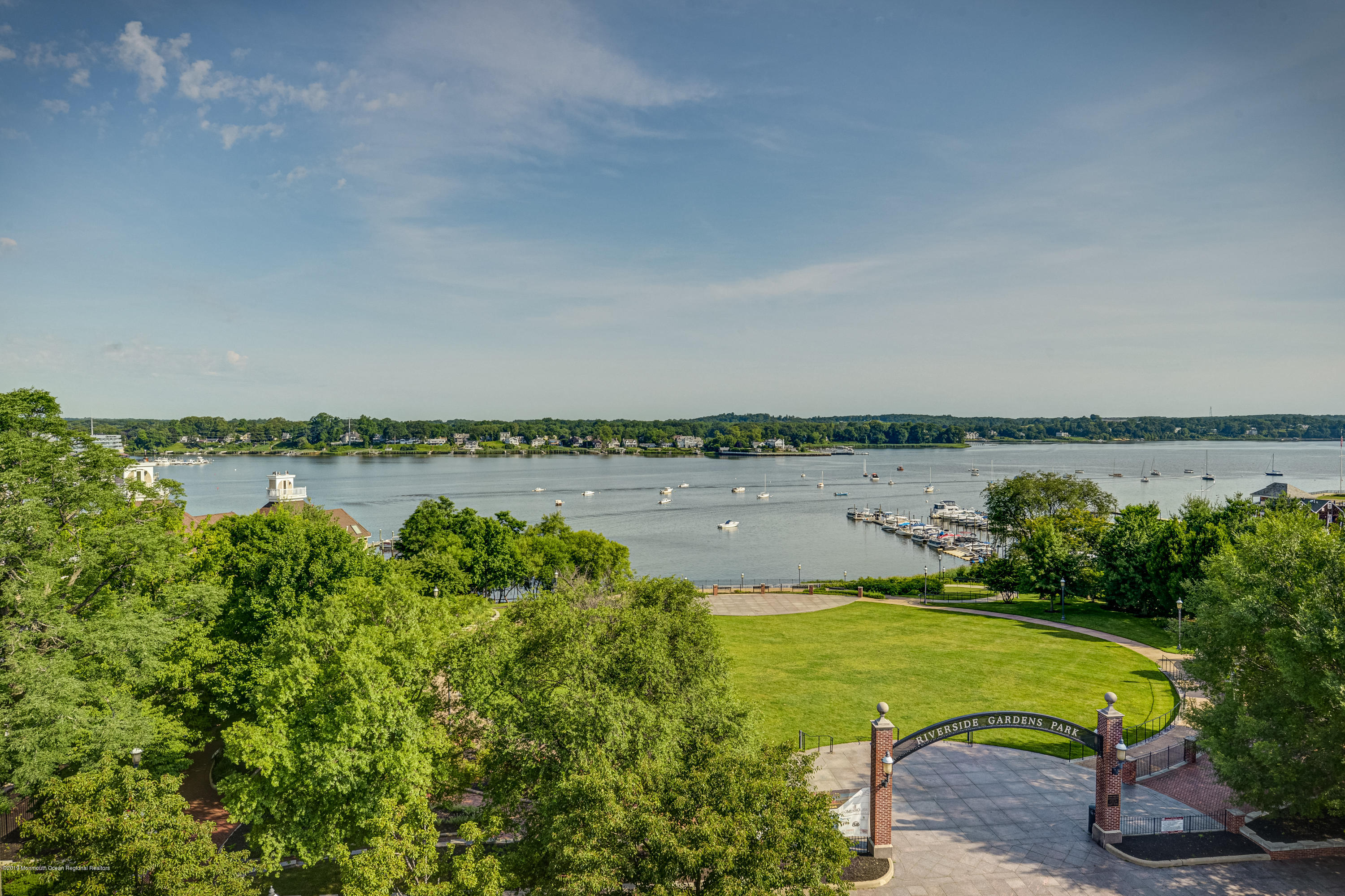 55 West Front Street, Unit 306 Red Bank, NJ 07701 - Photo 24 of 24 a view of a lake with houses in the back