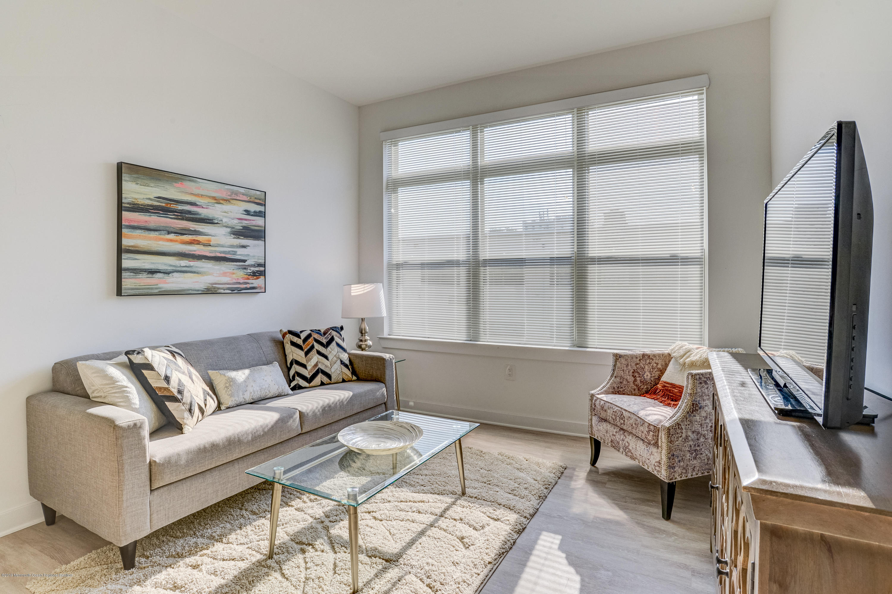55 West Front Street, Unit 306 Red Bank, NJ 07701 - Photo 10 of 24 a living room with furniture and a window