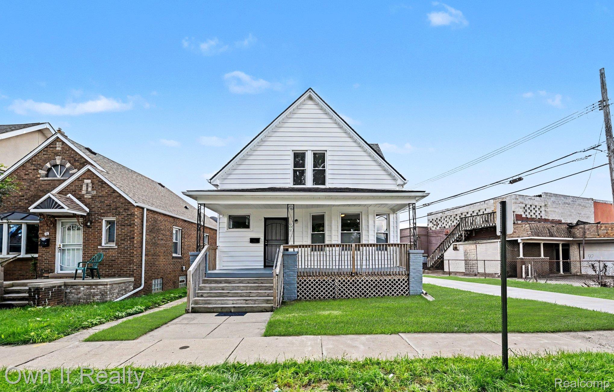44 Maple Street River Rouge, MI 48218 - Photo 1 of 33 White siding exterior with a prominent gabled roofline