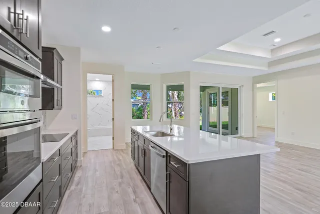 a kitchen with counter top space and wooden floor