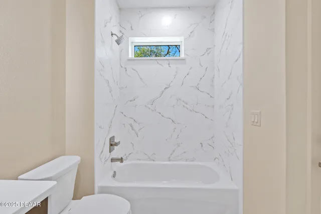 a bathroom with a bathtub and a toilet