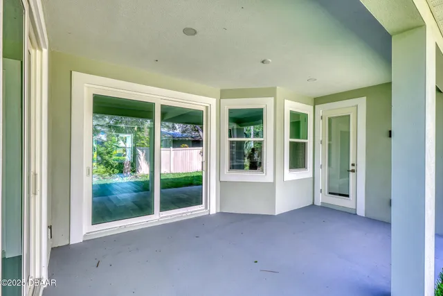 a view of a big room with sliding glass door and balcony