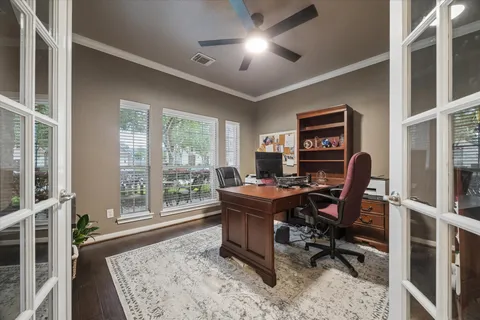 a view of a workspace with furniture and a window