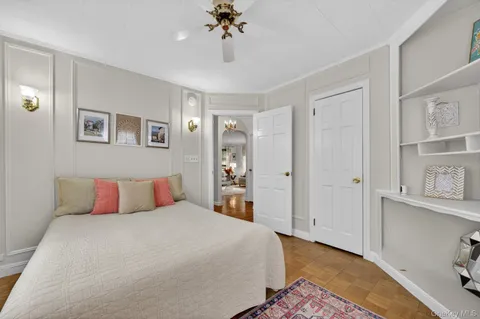 a bedroom with a large bed and a chandelier