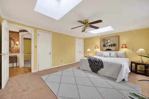 a living room with a couch and a view of dining room