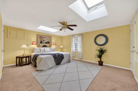 a spacious bedroom with a bed and a chandelier