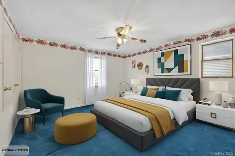 a bedroom with bed and a chandelier