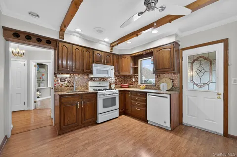 a kitchen with granite countertop a refrigerator stove top oven and sink