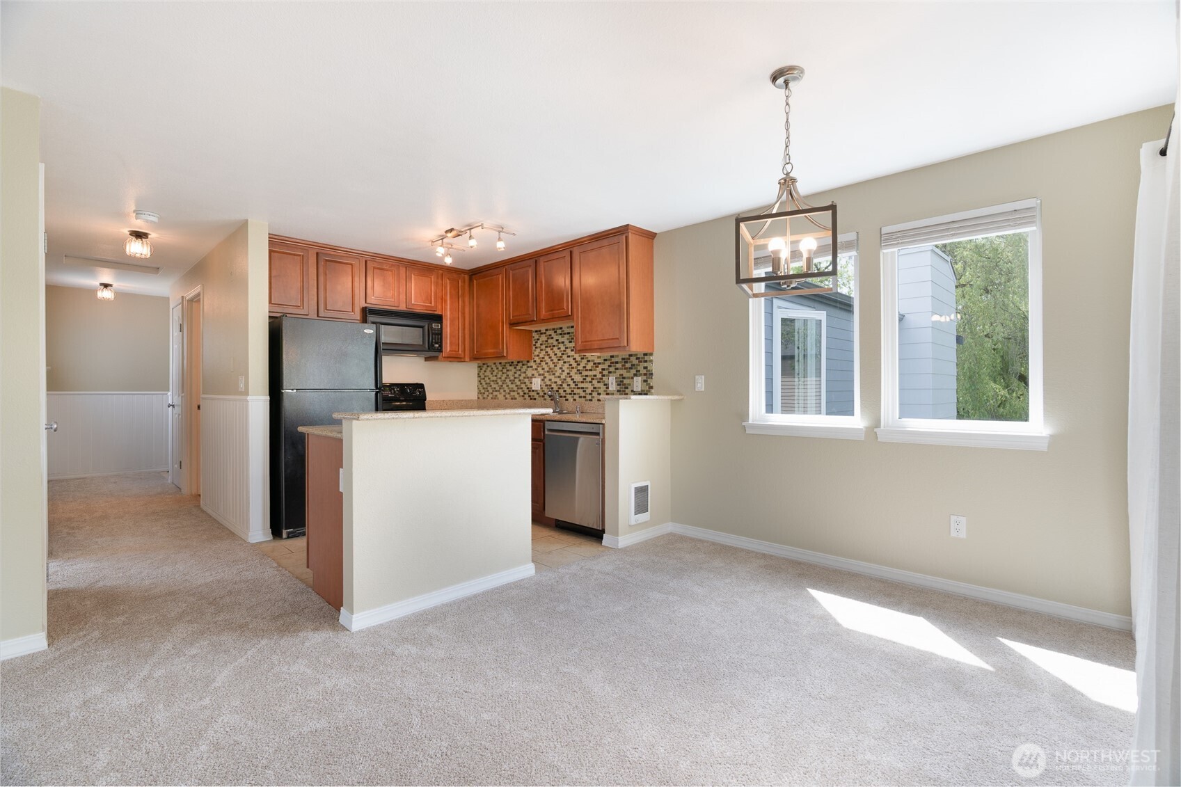 20320 Bothell Everett Highway, Unit D301 Bothell, WA 98012 - Photo 13 of 35 a kitchen with stainless steel appliances granite countertop a refrigerator a oven a sink with a dining table and chairs