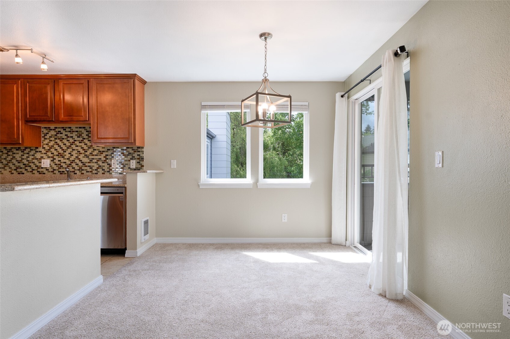 20320 Bothell Everett Highway, Unit D301 Bothell, WA 98012 - Photo 15 of 35 a view of a kitchen with a sink dishwasher and a refrigerator