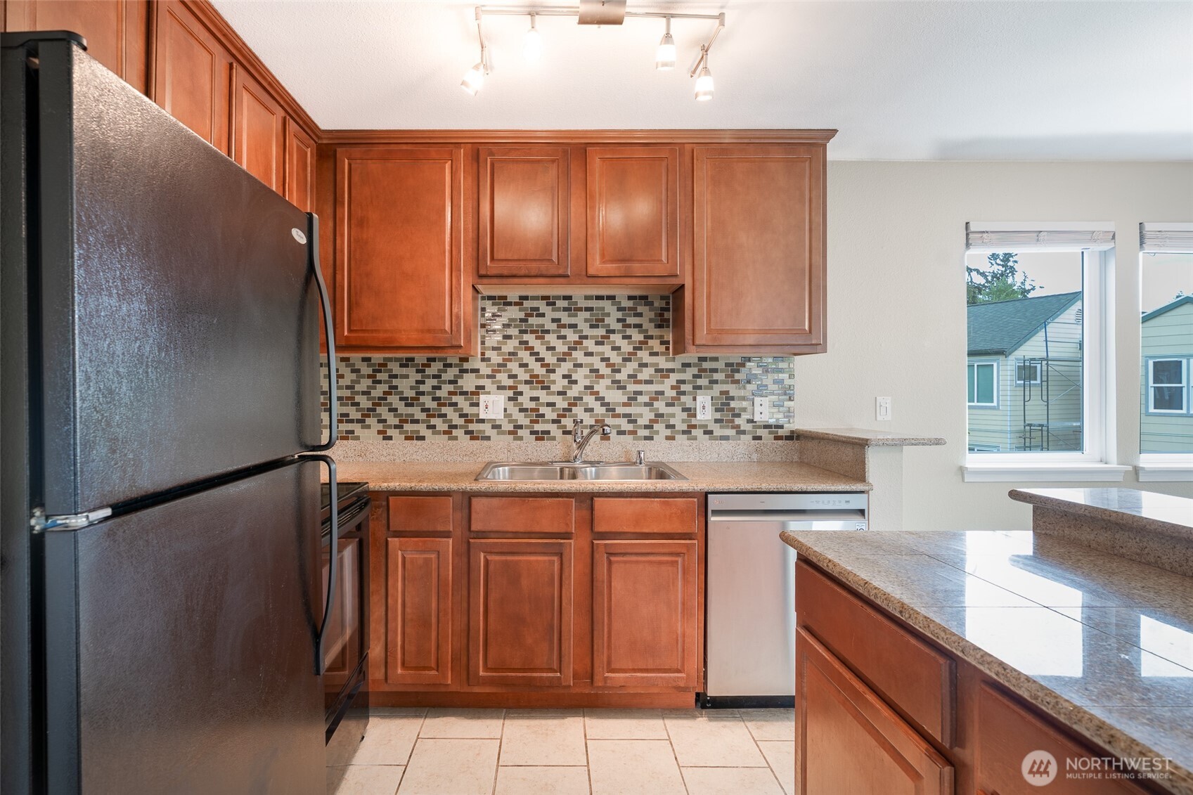 20320 Bothell Everett Highway, Unit D301 Bothell, WA 98012 - Photo 16 of 35 a kitchen with stainless steel appliances granite countertop cabinets and sink