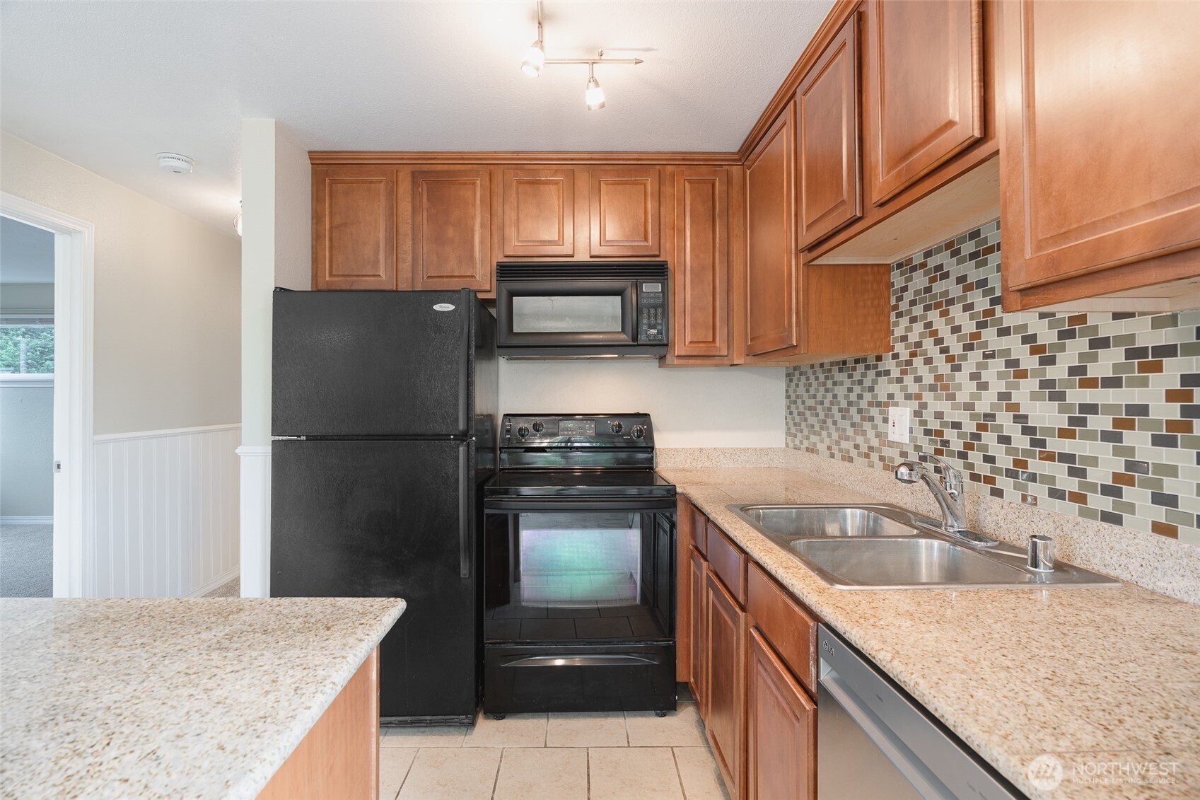 20320 Bothell Everett Highway, Unit D301 Bothell, WA 98012 - Photo 17 of 35 a kitchen with a sink a stove and refrigerator