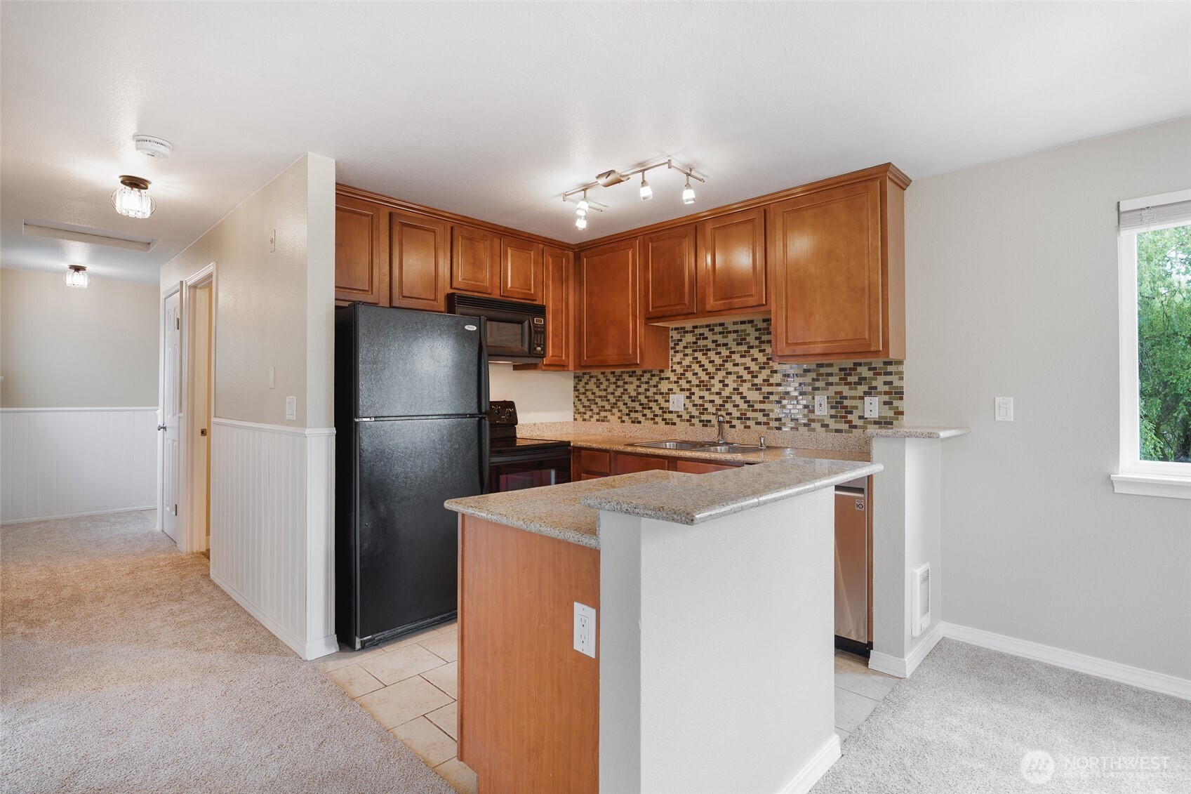 20320 Bothell Everett Highway, Unit D301 Bothell, WA 98012 - Photo 19 of 35 a kitchen with a refrigerator sink and cabinets