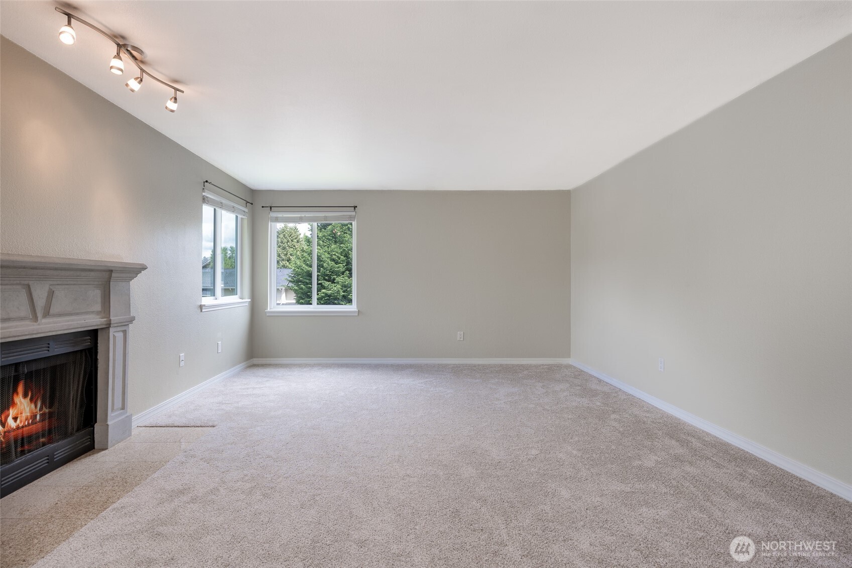 20320 Bothell Everett Highway, Unit D301 Bothell, WA 98012 - Photo 8 of 35 a view of an empty room with windows and a fireplace
