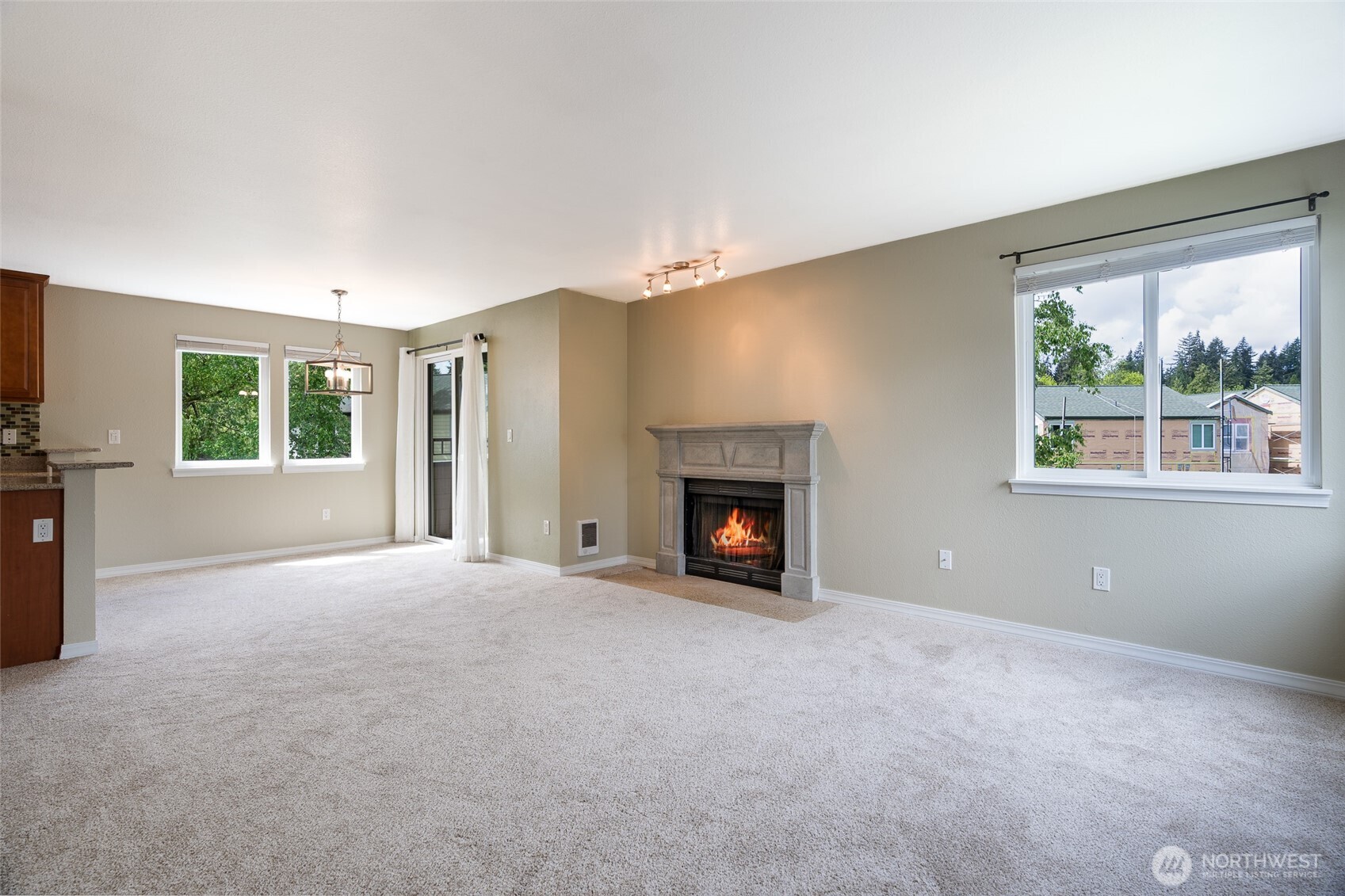 20320 Bothell Everett Highway, Unit D301 Bothell, WA 98012 - Photo 10 of 35 a view of an empty room with a fireplace and a window