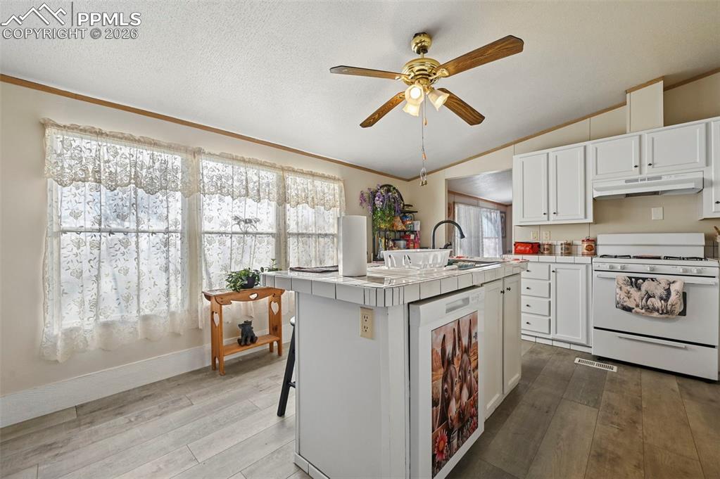 35875 Shear Road Yoder, CO 80864 - Photo 21 of 45 a kitchen with a stove window and cabinets