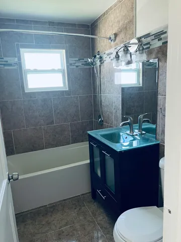 a bathroom with a sink a toilet and bathtub